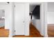 Bright hallway with hardwood floors and contrasting dark accent wall at end at 1141 Milstead Ne Ave, Conyers, GA 30012