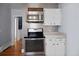 Kitchen featuring stainless steel appliances, countertops, and white cabinets at 1141 Milstead Ne Ave, Conyers, GA 30012