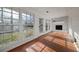 Bright sunroom with tile flooring, a white brick fireplace, and lots of natural light at 1141 Milstead Ne Ave, Conyers, GA 30012