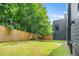 Expansive backyard with lush green lawn, privacy fence, and access to the home's exterior at 244 Locust Ne St # B, Atlanta, GA 30317