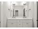 Bathroom with double sink vanity, marble countertop, and modern fixtures with a large mirror at 244 Locust Ne St # B, Atlanta, GA 30317