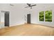Spacious bedroom with two windows, hardwood floors, a ceiling fan, and two interior doors at 244 Locust Ne St # B, Atlanta, GA 30317