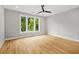 Bedroom showcasing hardwood floors and a large window with views of the trees at 244 Locust Ne St # B, Atlanta, GA 30317