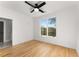 Sunlit bedroom with hardwood floors, a ceiling fan, and a doorway to the bathroom at 244 Locust Ne St # B, Atlanta, GA 30317