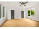 Spacious bedroom with two windows, hardwood floors, a ceiling fan, and two interior doors at 244 Locust Ne St # B, Atlanta, GA 30317