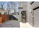 Modern home with grey siding, concrete driveway, and a black-framed glass door at 244 Locust Ne St # B, Atlanta, GA 30317