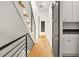 Hallway with wooden stairs, a wood floor, and a modern railing, featuring a sliding door at 244 Locust Ne St # B, Atlanta, GA 30317