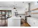 Modern kitchen featuring white cabinets, stainless steel appliances, and an island with a marble countertop at 244 Locust Ne St # B, Atlanta, GA 30317