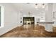 Open-concept living room with stained concrete floors, fireplace, and sliding doors to the backyard at 244 Locust Ne St # B, Atlanta, GA 30317