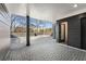 Covered brick patio with overhead lighting, a dark accent wall, and a view of the yard at 244 Locust Ne St # B, Atlanta, GA 30317