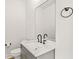 Chic powder room with gray vanity, granite countertop, modern fixtures, and a large mirror at 244 Locust Ne St # B, Atlanta, GA 30317