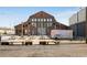 Outdoor seating at the Pullman Yards with picnic tables and umbrella stand out front with a historic brick building at 244 Locust Ne St # B, Atlanta, GA 30317