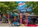 Vibrant restaurant exterior with artistic murals, colorful seating, and a lively outdoor dining area at 244 Locust Ne St # B, Atlanta, GA 30317