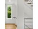 Staircase featuring hardwood steps, modern railings and a sunlit window at 244 Locust Ne St # B, Atlanta, GA 30317