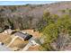 A high-angle view of several homes with well-kept lawns among mature trees in a tranquil neighborhood at 3001 W Potomac Dr, Atlanta, GA 30344