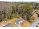 An aerial shot shows the property with its manicured lawn, a small shed, and many surrounding mature trees at 3001 W Potomac Dr, Atlanta, GA 30344