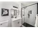 Modern bathroom with a black framed shower, black hardware, and a white vanity at 3001 W Potomac Dr, Atlanta, GA 30344