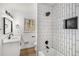 Modern bathroom with a shower/tub combo, updated vanity, and black hardware at 3001 W Potomac Dr, Atlanta, GA 30344