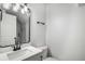 Modern bathroom featuring a vanity with a quartz countertop, a framed mirror, and updated fixtures at 3001 W Potomac Dr, Atlanta, GA 30344