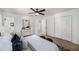 Bright bedroom featuring a ceiling fan, closet, bathroom access, and a modern animal print rug at 3001 W Potomac Dr, Atlanta, GA 30344