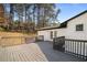 View of the deck with french doors leading to a bright white brick house with black trim at 3001 W Potomac Dr, Atlanta, GA 30344