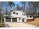 Two-story home featuring a light-painted brick facade, dark shutters, and a spacious two-car garage at 3001 W Potomac Dr, Atlanta, GA 30344