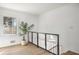 Bright hallway with wood floors, stairs, and a modern glass railing at 3001 W Potomac Dr, Atlanta, GA 30344