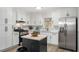 Bright kitchen with an island, stainless steel appliances, and light granite countertops at 3001 W Potomac Dr, Atlanta, GA 30344