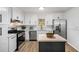 Bright modern kitchen with an island, stainless steel appliances, and subway tile backsplash at 3001 W Potomac Dr, Atlanta, GA 30344