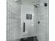 Modern tiled shower with black hardware and black tile floor in renovated home at 3001 W Potomac Dr, Atlanta, GA 30344