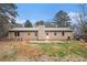 Back exterior of home, including a patio, trees and green space at 4775 Hemlock Se Dr, Conyers, GA 30094