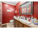 Red bathroom with a large sink vanity and a decorative mirror at 4775 Hemlock Se Dr, Conyers, GA 30094