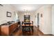 Traditional dining room with elegant chandelier, dark wood floors, and classic furnishings at 4775 Hemlock Se Dr, Conyers, GA 30094