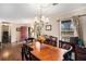 Traditional dining room with classic chandelier and dark wood floors for memorable gatherings at 4775 Hemlock Se Dr, Conyers, GA 30094