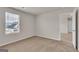 Neutral bedroom featuring carpet, a window providing natural light, and an open doorway at 654 Egrets Lot 65 Lndg, Covington, GA 30014