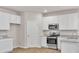 Bright kitchen featuring stainless steel appliances and granite counters at 654 Egrets Lot 65 Lndg, Covington, GA 30014