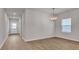 Bright living room featuring hardwood floors and modern lighting at 654 Egrets Lot 65 Lndg, Covington, GA 30014