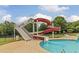 Community pool area showcasing a thrilling red waterslide surrounded by well-maintained landscaping at 654 Egrets Lot 65 Lndg, Covington, GA 30014