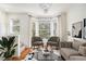 Bright living room with hardwood floors, bay window, modern chandelier, and neutral furniture at 951 Glenwood Se Ave # 704, Atlanta, GA 30316