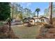 Landscaped backyard with a covered gazebo featuring a stone fire pit at 3401 Lori Ln, Atlanta, GA 30340