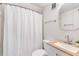 Bright bathroom with a white vanity, framed mirror, and shower with textured white curtain at 3401 Lori Ln, Atlanta, GA 30340