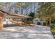 Long driveway leading to a carport and storage building in a landscaped backyard at 3401 Lori Ln, Atlanta, GA 30340