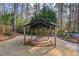 Stone fire pit inside the gazebo in a beautifully landscaped backyard at 3401 Lori Ln, Atlanta, GA 30340