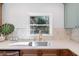 Close up of kitchen featuring quartz counters, stainless steel sink and a backyard view at 3401 Lori Ln, Atlanta, GA 30340