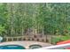 Scenic backyard with a view of trees and a path leading to the dock and water at 5040 Blackberry Ln, Buford, GA 30518