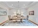 Elegant dining room featuring hardwood floors, stylish chandelier, and detailed trim work at 5040 Blackberry Ln, Buford, GA 30518