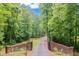 Gated driveway leading to the property, offering security and a grand entrance surrounded by greenery at 5040 Blackberry Ln, Buford, GA 30518