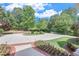 Circular driveway with lush landscaping leading to a beautiful home at 5040 Blackberry Ln, Buford, GA 30518