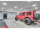 Bright, spacious garage featuring a red Jeep, ideal for car enthusiasts and home vehicle maintenance at 5040 Blackberry Ln, Buford, GA 30518