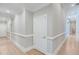 Hallway featuring hardwood flooring, white molding, and neutral wall paint at 5040 Blackberry Ln, Buford, GA 30518